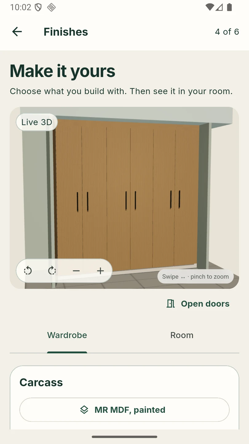 Actual Android app showing oak wardrobe fronts in a sage room and the Finishes controls